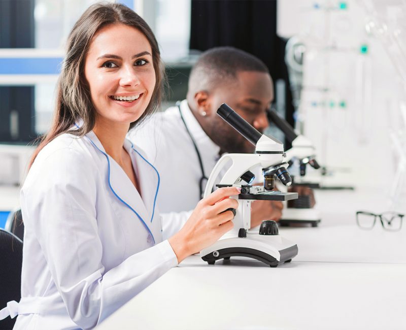 smiling doctor microscope