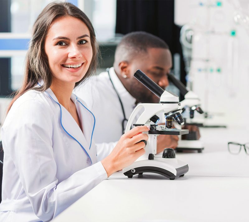 smiling doctor microscope