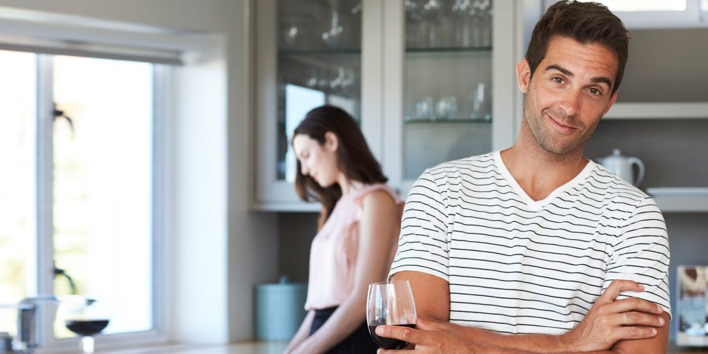 Guy smiling girl cooking in back