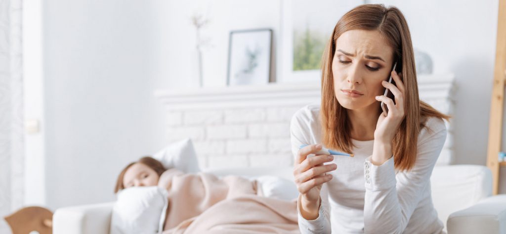 Mom taking child's temperature
